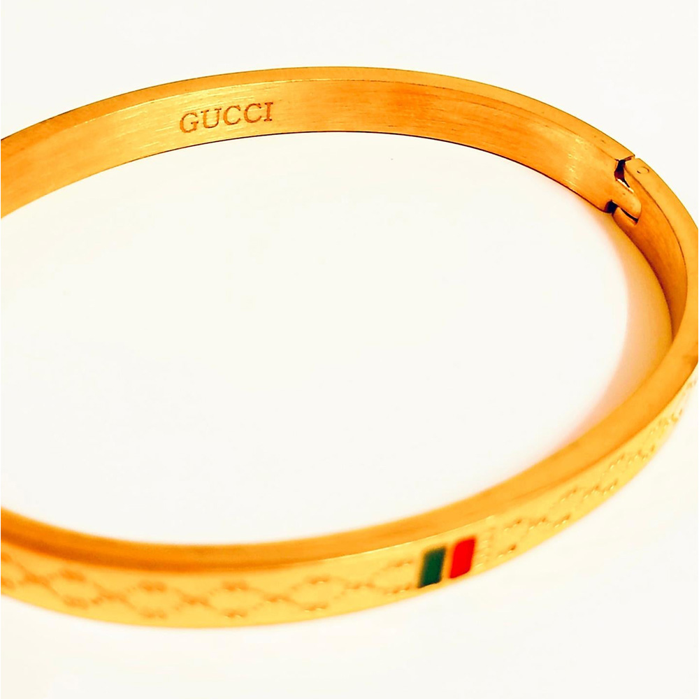 Gucci's Classic Touch: Gold-Tone Bangle with Iconic Stripes