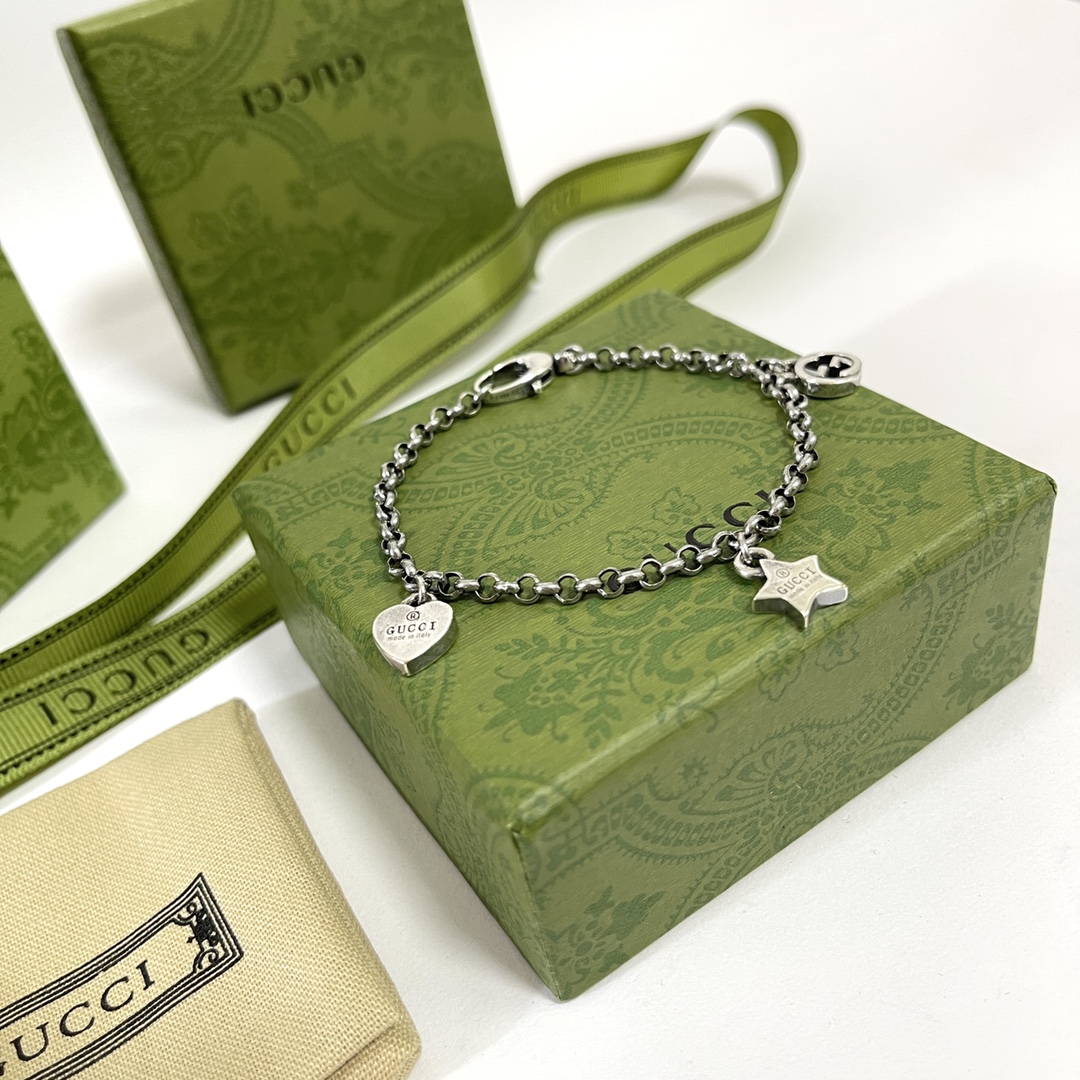 Gucci's Starry Charm: Silver Bracelet with G and Star Pendants